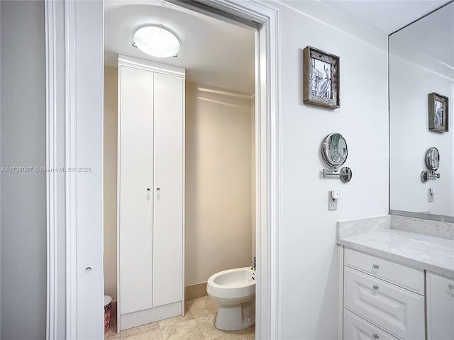 bathroom with a bidet and vanity