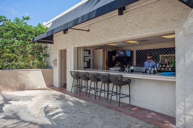 view of patio with an outdoor bar