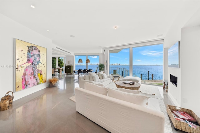 living room featuring a water view and a wall of windows