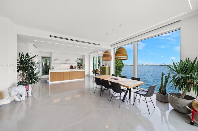 dining space featuring a water view