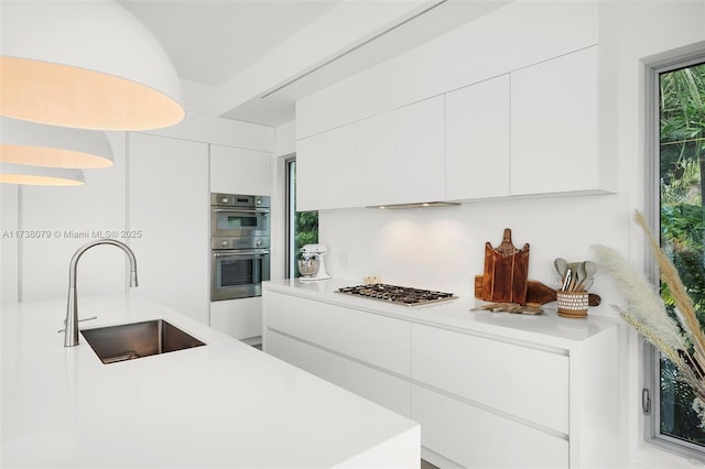 kitchen featuring sink, white cabinets, and appliances with stainless steel finishes