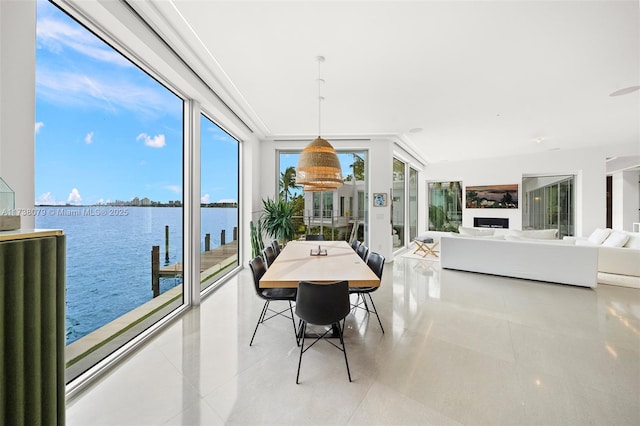 sunroom with a healthy amount of sunlight and a water view