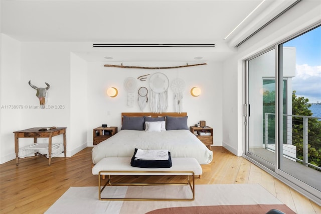 bedroom featuring light wood-type flooring and access to outside