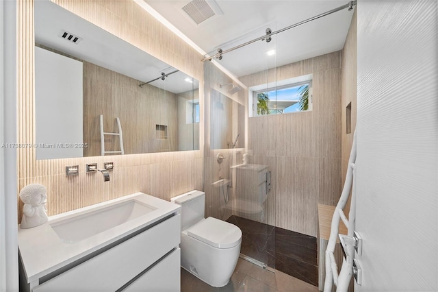 bathroom with a shower, tile walls, vanity, and toilet