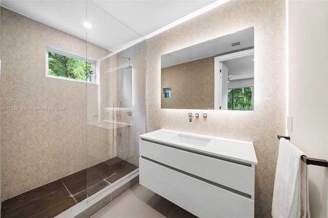 bathroom featuring vanity and a tile shower