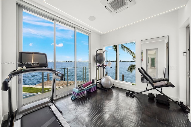 exercise area featuring a water view