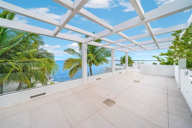 view of patio with a water view and a pergola