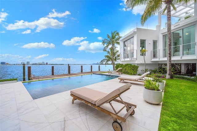 view of pool featuring a water view and a patio area