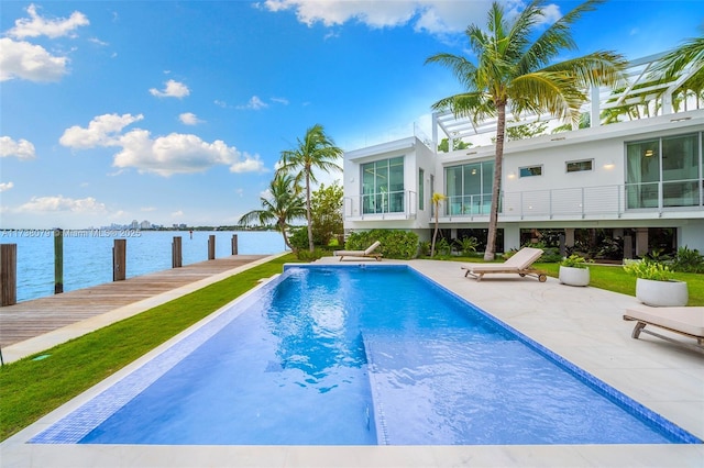 view of pool featuring a patio area, a boat dock, and a water view