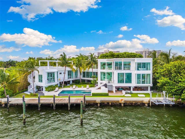 back of house with a water view, a balcony, and a patio