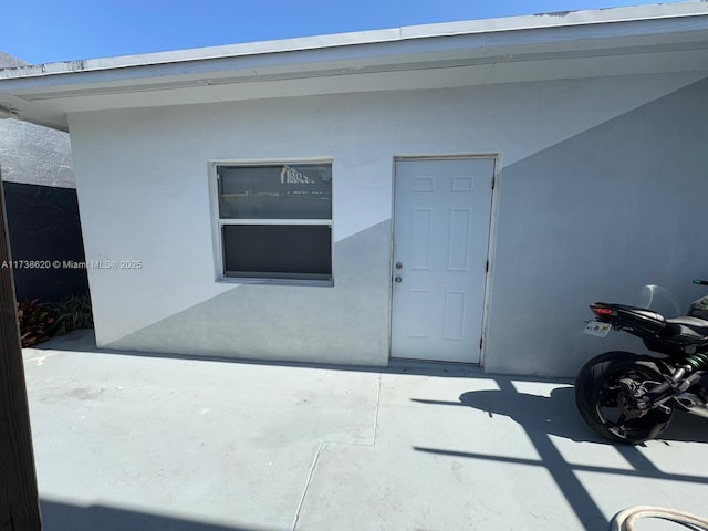 entrance to property featuring a patio area