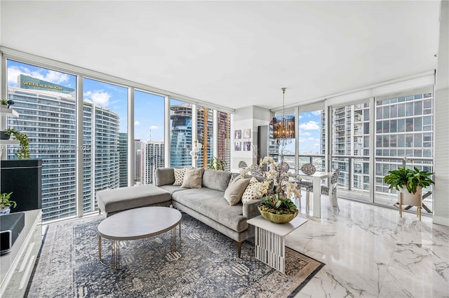 living area featuring floor to ceiling windows, a city view, plenty of natural light, and a notable chandelier