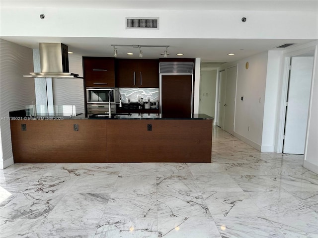 kitchen with marble finish floor, modern cabinets, visible vents, ventilation hood, and built in appliances
