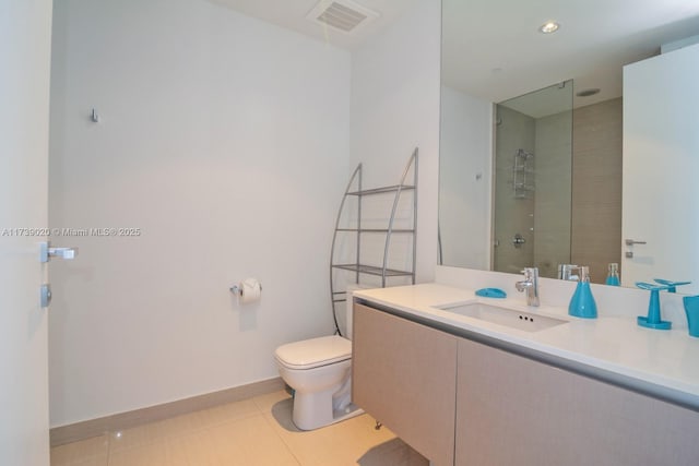 bathroom featuring walk in shower, vanity, toilet, and tile patterned flooring