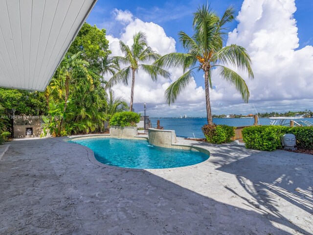 view of pool featuring a patio, pool water feature, and a water view