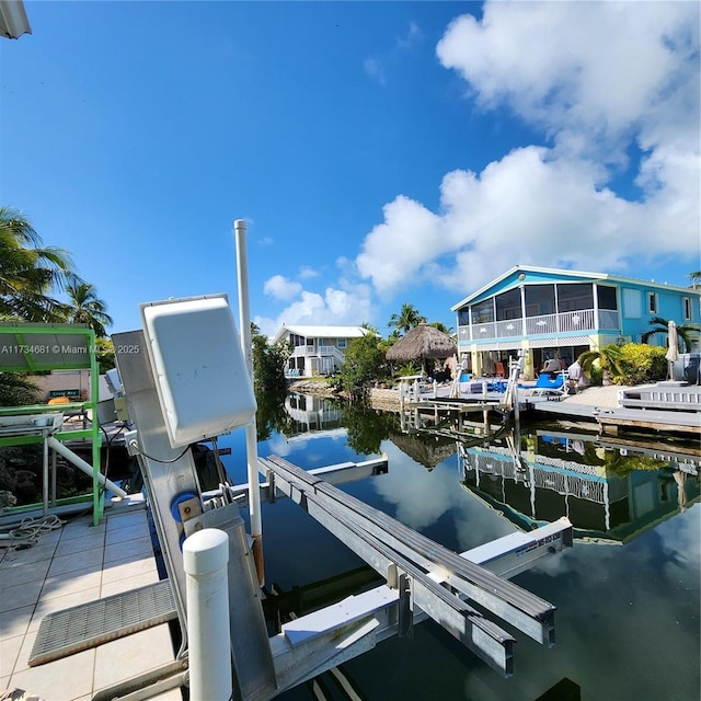 dock area with boat lift and a water view