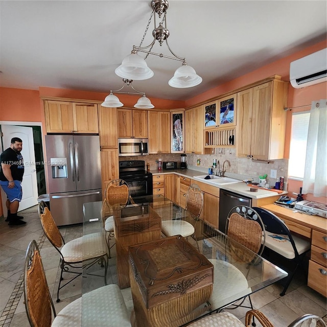 kitchen featuring sink, a wall mounted air conditioner, appliances with stainless steel finishes, pendant lighting, and backsplash