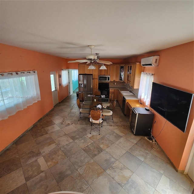 living room with stone finish floor, ceiling fan, and an AC wall unit