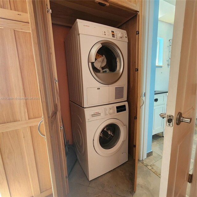 laundry area featuring stacked washing maching and dryer