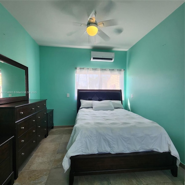bedroom featuring baseboards, a ceiling fan, and a wall mounted AC