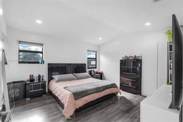 bedroom with dark hardwood / wood-style floors and vaulted ceiling