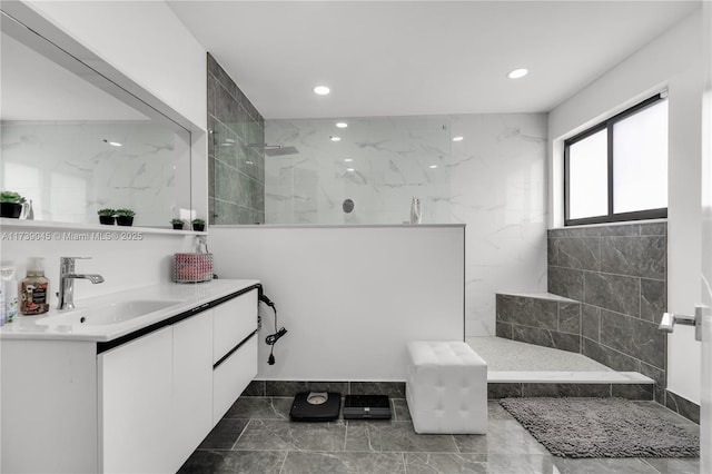 bathroom featuring vanity and a tile shower