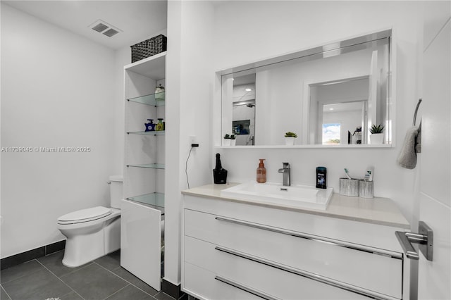 bathroom featuring vanity, toilet, and tile patterned flooring