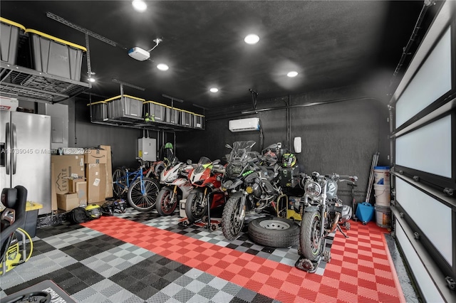 garage with a garage door opener, a wall mounted AC, and stainless steel fridge