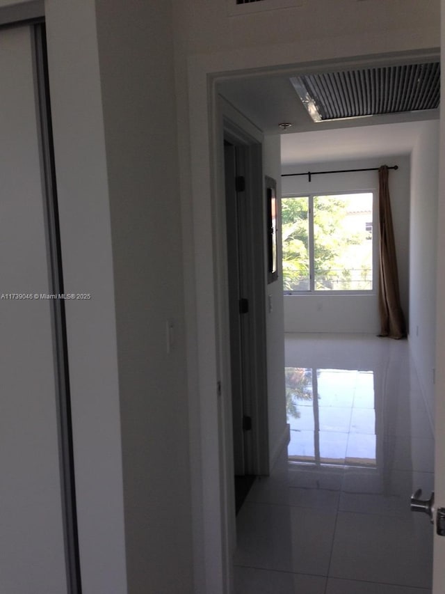 corridor with tile patterned flooring