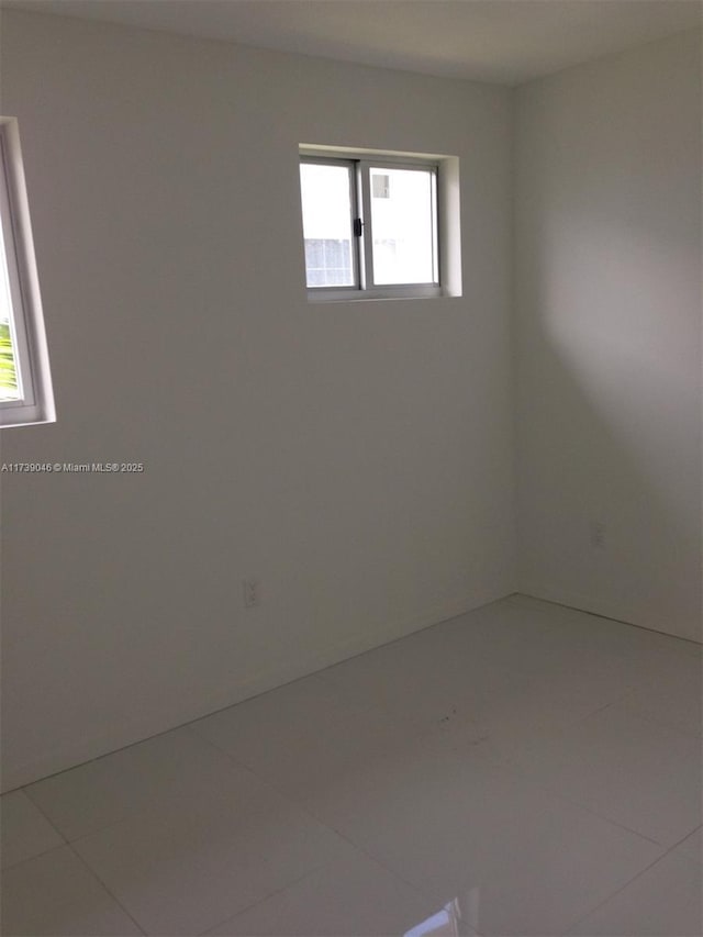 unfurnished room featuring tile patterned flooring