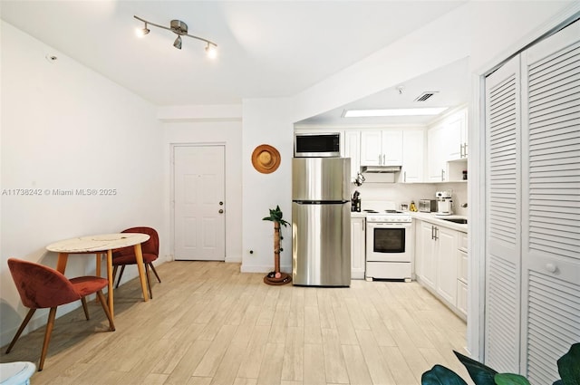 kitchen featuring white cabinetry, stainless steel appliances, and light hardwood / wood-style floors