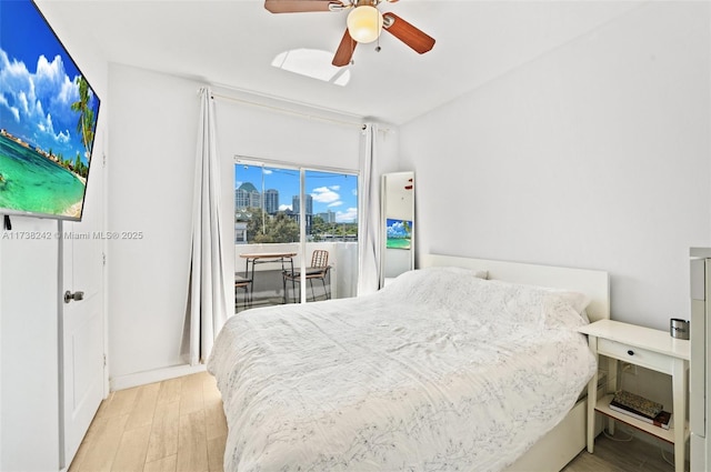 bedroom featuring ceiling fan, light hardwood / wood-style flooring, and access to outside