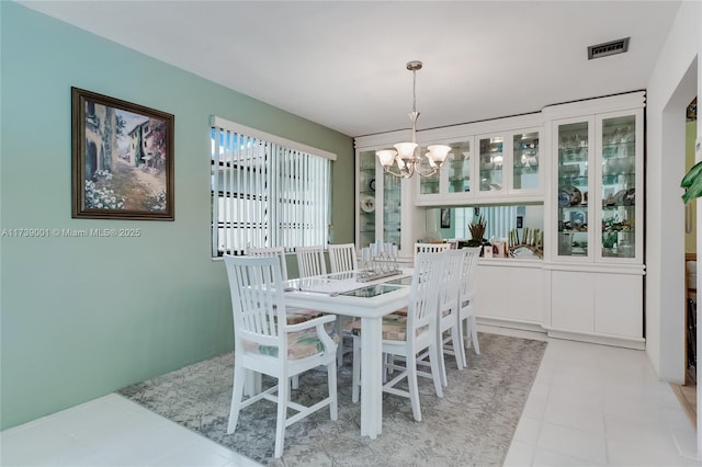 dining space featuring a notable chandelier