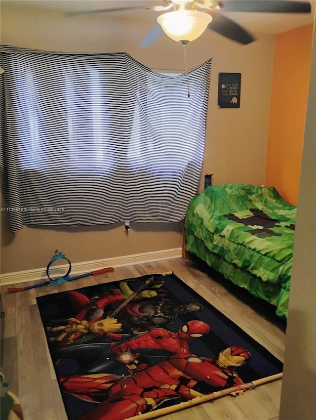 bedroom with hardwood / wood-style flooring and ceiling fan