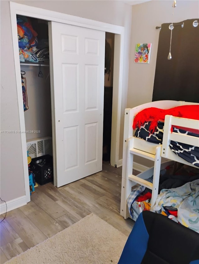 bedroom featuring light hardwood / wood-style floors and a closet