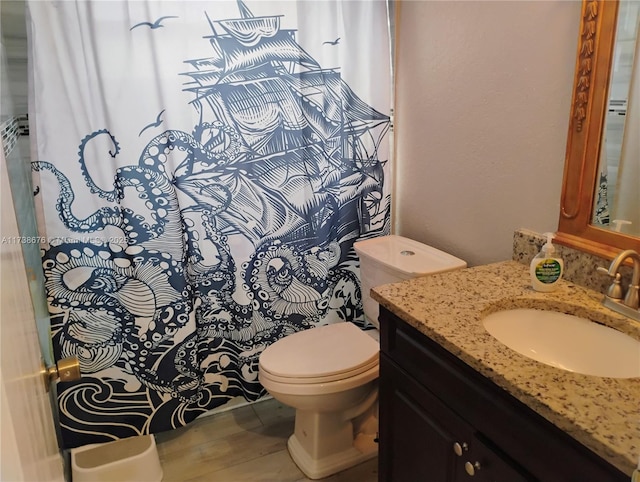 bathroom featuring hardwood / wood-style flooring, vanity, and toilet