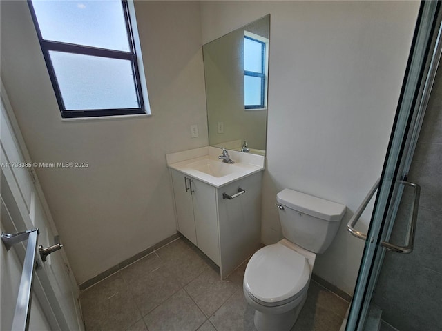 bathroom featuring tile patterned floors, vanity, toilet, and a shower with shower door