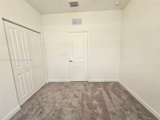 unfurnished bedroom featuring carpet floors and a closet