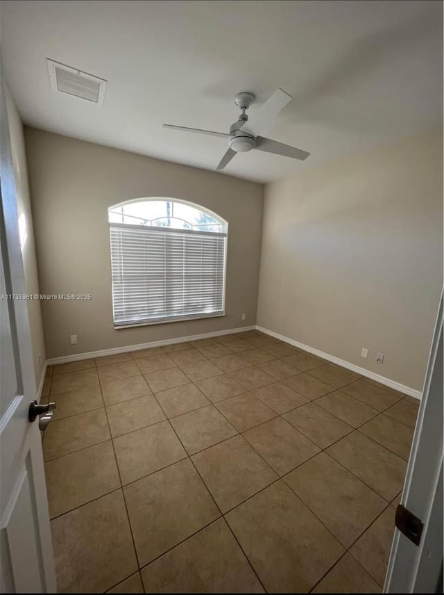 tiled empty room with ceiling fan