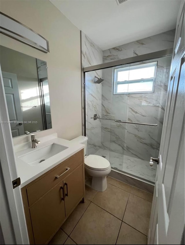 bathroom with walk in shower, vanity, and toilet