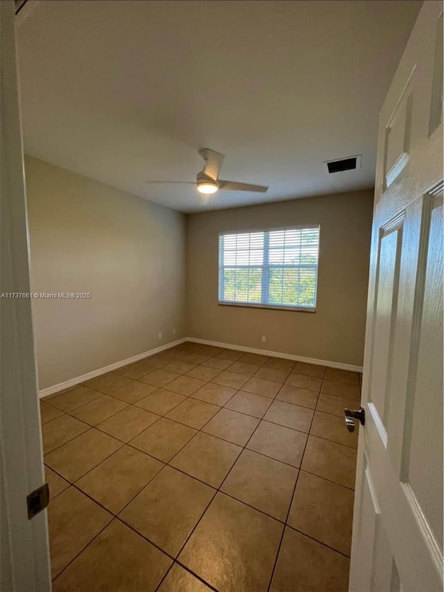 unfurnished room featuring light tile patterned flooring and ceiling fan