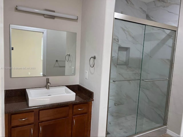 bathroom featuring vanity and an enclosed shower