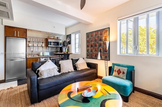 living room featuring beam ceiling