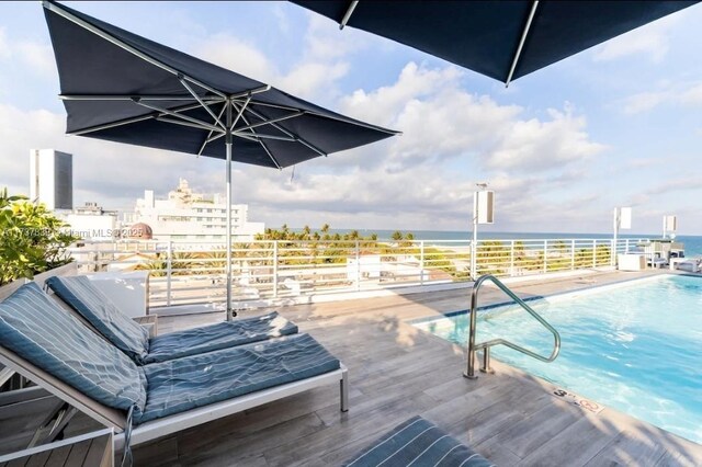 view of swimming pool with a water view