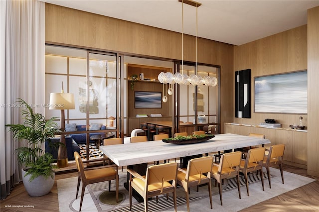 dining space with light parquet floors and wooden walls