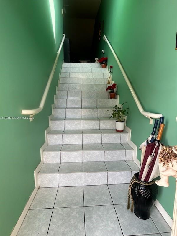 stairs featuring tile patterned flooring