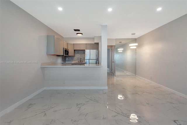 kitchen featuring gray cabinets, stainless steel appliances, tasteful backsplash, decorative light fixtures, and kitchen peninsula