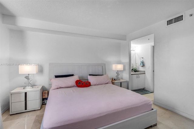 bedroom featuring ensuite bathroom