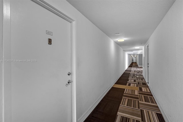 hall featuring a textured ceiling