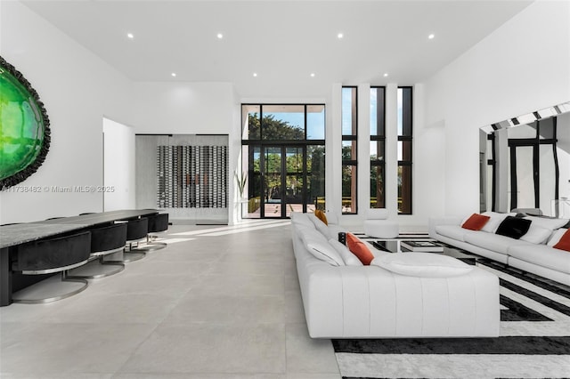 living room featuring a towering ceiling